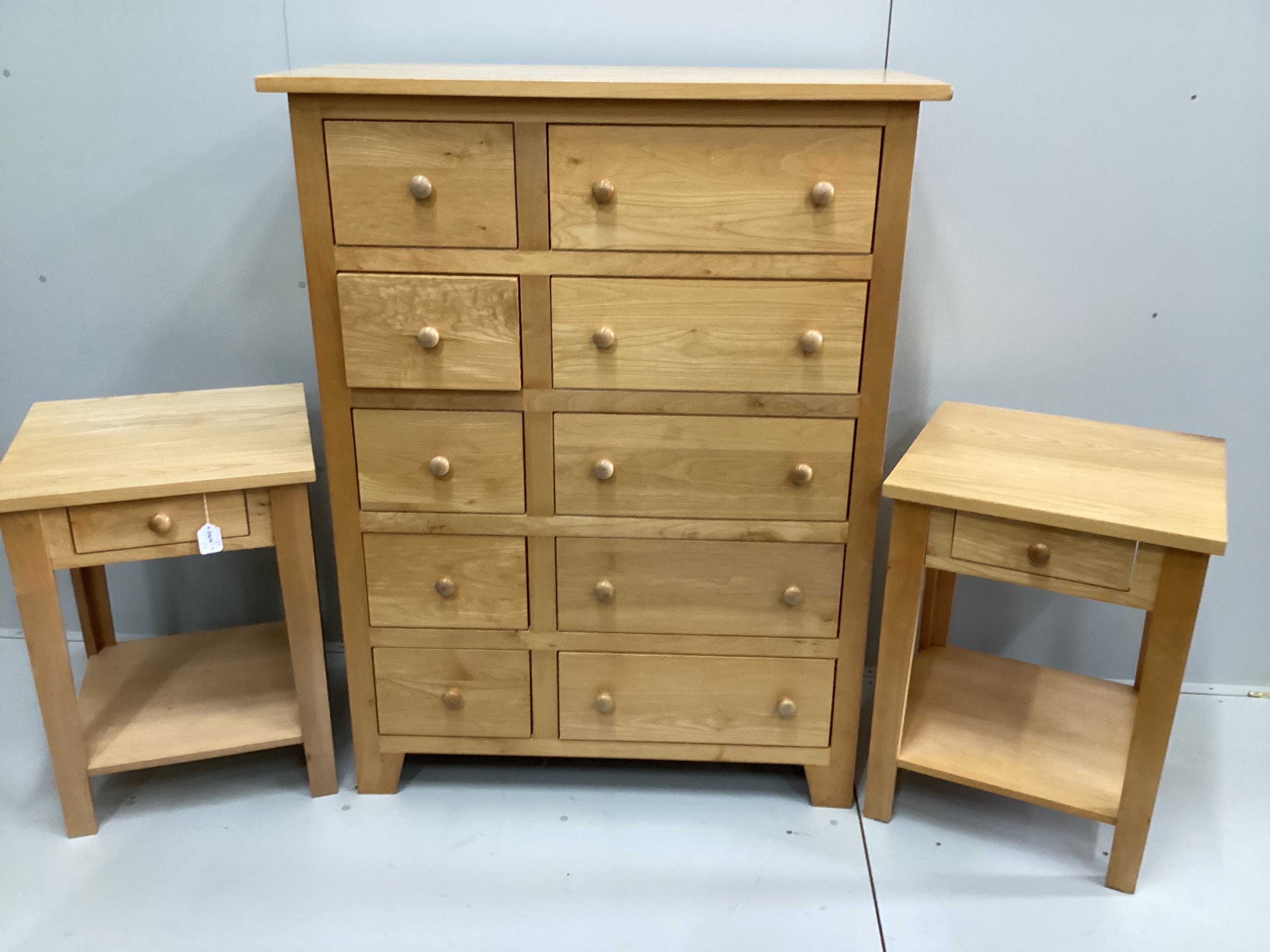 A contemporary maple ten drawer chest, width 106cm, depth 53cm, height 138cm and a pair of matching bedside tables